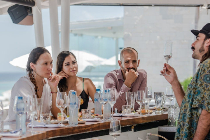 a group of people sitting at a table with wine glasses